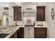 Kitchen with granite countertops, custom cabinetry, and gas cooktop at 2914 Shipston Ave, New Port Richey, FL 34655