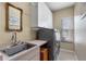 Laundry room with washer, dryer, sink, and ample cabinet storage at 2914 Shipston Ave, New Port Richey, FL 34655