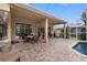 Covered patio with seating area adjacent to the pool and house at 2914 Shipston Ave, New Port Richey, FL 34655