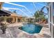 Large screened pool and patio with spacious seating and outdoor dining at 2914 Shipston Ave, New Port Richey, FL 34655