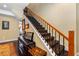 Elegant staircase with black metal railings and patterned carpet runner at 2914 Shipston Ave, New Port Richey, FL 34655