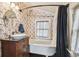 Bathroom with clawfoot tub and floral wallpaper at 301 Old Hopewell Rd, Plant City, FL 33567