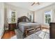 Main bedroom with large bed and hardwood floors at 301 Old Hopewell Rd, Plant City, FL 33567