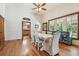 Bright dining room with hardwood floors, white table, and view into kitchen at 301 Old Hopewell Rd, Plant City, FL 33567
