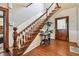 Grand entryway with wood staircase and hardwood floors at 301 Old Hopewell Rd, Plant City, FL 33567