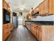 Long kitchen with stainless steel appliances and wood cabinets at 301 Old Hopewell Rd, Plant City, FL 33567