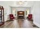 Living room with hardwood floors, fireplace, and two armchairs at 301 Old Hopewell Rd, Plant City, FL 33567