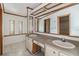 Double vanity bathroom with large mirror and tile floor at 35934 Verano Ln, Zephyrhills, FL 33541