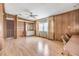 Common area with wood paneling, light floors, and built-in shelving at 35934 Verano Ln, Zephyrhills, FL 33541
