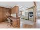 Eat-in kitchen with a breakfast bar, wood cabinets, and a built-in microwave at 35934 Verano Ln, Zephyrhills, FL 33541