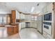 Kitchen with light wood cabinets, stainless steel appliances, and tile floor at 35934 Verano Ln, Zephyrhills, FL 33541