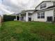 Large backyard with covered patio and ample green space at 4709 Corsage Dr, Lutz, FL 33558