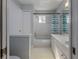 Clean bathroom with a bathtub, shower, and marble vanity at 4709 Corsage Dr, Lutz, FL 33558
