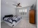 Spacious bedroom with a ceiling fan, large window, and wood dresser at 4709 Corsage Dr, Lutz, FL 33558