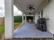 Relaxing covered patio with ceiling fans and outdoor dining area at 4709 Corsage Dr, Lutz, FL 33558