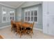 Charming dining room with wood table and chairs, and plantation shutters at 4709 Corsage Dr, Lutz, FL 33558