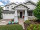 Two-story home with white exterior, landscaped yard, and a welcoming front porch at 4709 Corsage Dr, Lutz, FL 33558