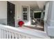Relaxing front porch with white railing, comfortable seating, and potted plants at 4709 Corsage Dr, Lutz, FL 33558