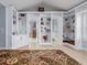 Bright hallway with built-in shelving and access to bathroom and bedroom at 4709 Corsage Dr, Lutz, FL 33558