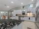 Modern kitchen with white cabinets, granite countertops, and stainless steel appliances at 4709 Corsage Dr, Lutz, FL 33558