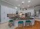 Eat-in kitchen with large island, granite counters & teal stools at 4709 Corsage Dr, Lutz, FL 33558