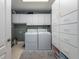 Bright laundry room with washer, dryer, ample cabinetry, and storage at 4709 Corsage Dr, Lutz, FL 33558