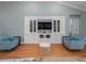 Spacious living room with hardwood floors and built-in entertainment center at 4709 Corsage Dr, Lutz, FL 33558