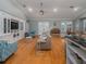 Bright living room with hardwood floors, built-in shelving & vaulted ceiling at 4709 Corsage Dr, Lutz, FL 33558