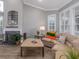 Spacious living room with a fireplace, large windows, and comfortable seating at 4709 Corsage Dr, Lutz, FL 33558