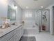 Main bathroom with double vanity, soaking tub, and walk-in shower at 4709 Corsage Dr, Lutz, FL 33558