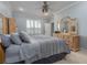 Main bedroom with a king-size bed, carpeted floors, and large windows at 4709 Corsage Dr, Lutz, FL 33558