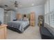 Main bedroom with carpeted floors, a ceiling fan, and plenty of closet space at 4709 Corsage Dr, Lutz, FL 33558