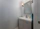 Clean powder room with modern vanity and a framed mirror at 4709 Corsage Dr, Lutz, FL 33558
