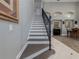Elegant staircase with dark wood and white risers, leading to upper level at 4709 Corsage Dr, Lutz, FL 33558