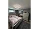 Bedroom with gray walls, a gray upholstered bed, and a dresser at 4841 Zodiac Ave, Holiday, FL 34690