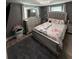Bedroom with gray walls, a gray upholstered bed, and a dresser at 4841 Zodiac Ave, Holiday, FL 34690