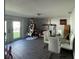 Dining room with glass table, white chairs, and French doors leading to backyard at 4841 Zodiac Ave, Holiday, FL 34690