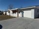 Newly renovated home with a gray exterior, attached garage, and well-maintained lawn at 4841 Zodiac Ave, Holiday, FL 34690