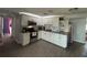 Modern kitchen with white cabinets, granite countertops, and stainless steel appliances at 4841 Zodiac Ave, Holiday, FL 34690