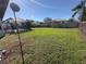 Large backyard with grassy area and screened enclosure at 491 Allworthy St, Port Charlotte, FL 33954