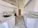 White kitchen with ample cabinetry and tile flooring at 491 Allworthy St, Port Charlotte, FL 33954