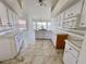 Kitchen with island, white cabinets, and tile floors at 491 Allworthy St, Port Charlotte, FL 33954