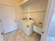 Laundry room with washer, dryer and utility sink at 491 Allworthy St, Port Charlotte, FL 33954