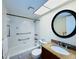 Clean bathroom with granite vanity, bathtub, and large mirror at 4910 Bay Ne St # 103, St Petersburg, FL 33703
