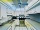Galley kitchen with stainless steel appliances and light wood cabinets at 4910 Bay Ne St # 103, St Petersburg, FL 33703