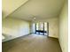 Open living room has neutral paint and carpet with large sliding glass doors to porch at 4910 Bay Ne St # 103, St Petersburg, FL 33703