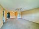 Spacious living room showcases neutral paint, carpet, and a wide view into other rooms at 4910 Bay Ne St # 103, St Petersburg, FL 33703