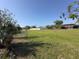 Large grassy backyard with white fence at 10 Golfview S Rd, Rotonda West, FL 33947
