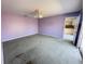 Primary bedroom with lavender walls and carpet flooring at 10 Golfview S Rd, Rotonda West, FL 33947