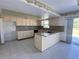 Kitchen with light cabinets, granite counters, and tile floor at 10 Golfview S Rd, Rotonda West, FL 33947
